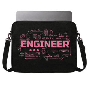 A black laptop sleeve with a pink graphic design that reads 'TRUST ME, I'M AN ENGINEER' surrounded by engineering-themed line drawings, shown with a laptop partially inserted. The sleeve has a black shoulder strap and is photographed against a plain white background.