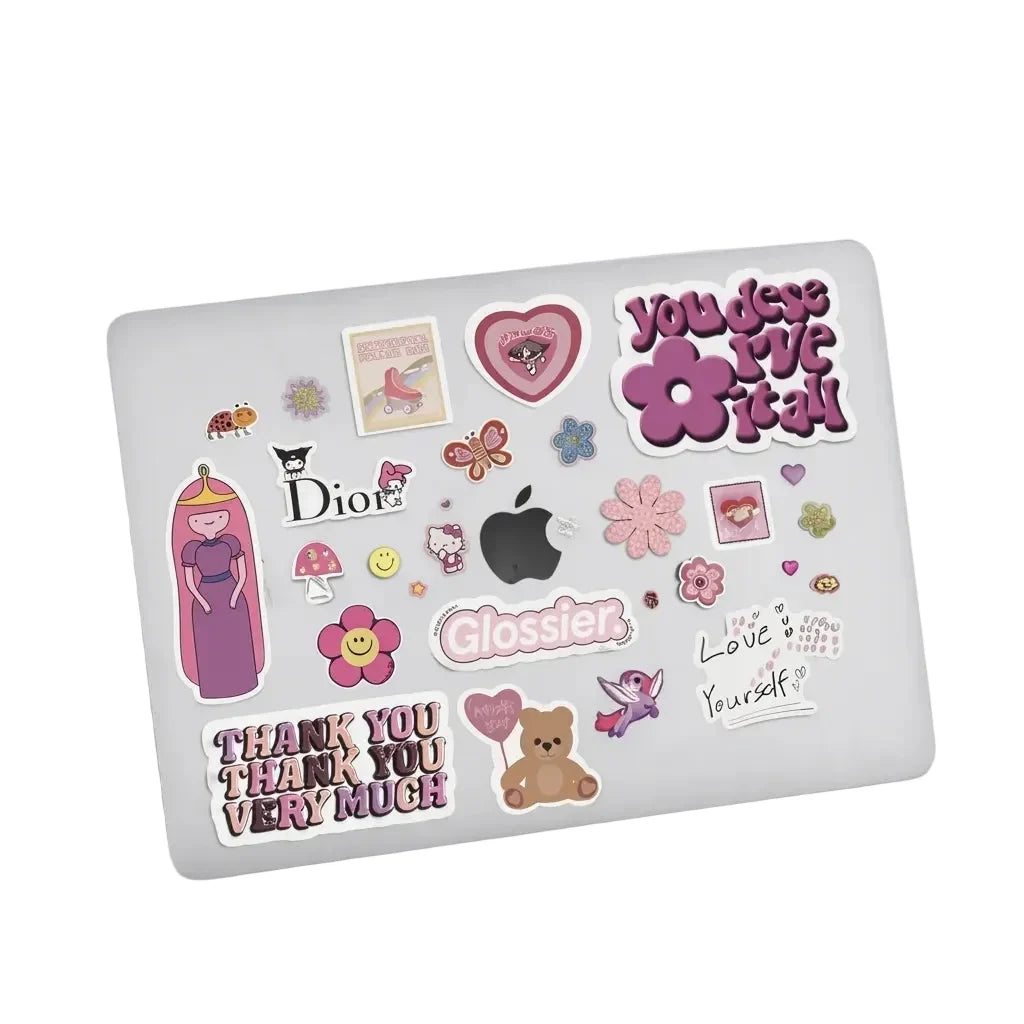 Top view of a silver laptop decorated with assorted pink aesthetic stickers, isolated on a plain white background