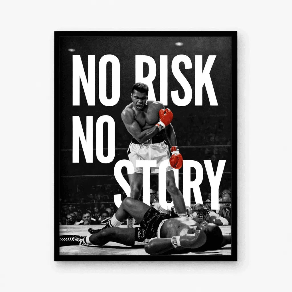 A framed black and white boxing poster featuring a boxer standing over an opponent in the ring, with large white text reading 'NO RISK NO STORY' and small red accents on the gloves, shown against a light gray background.