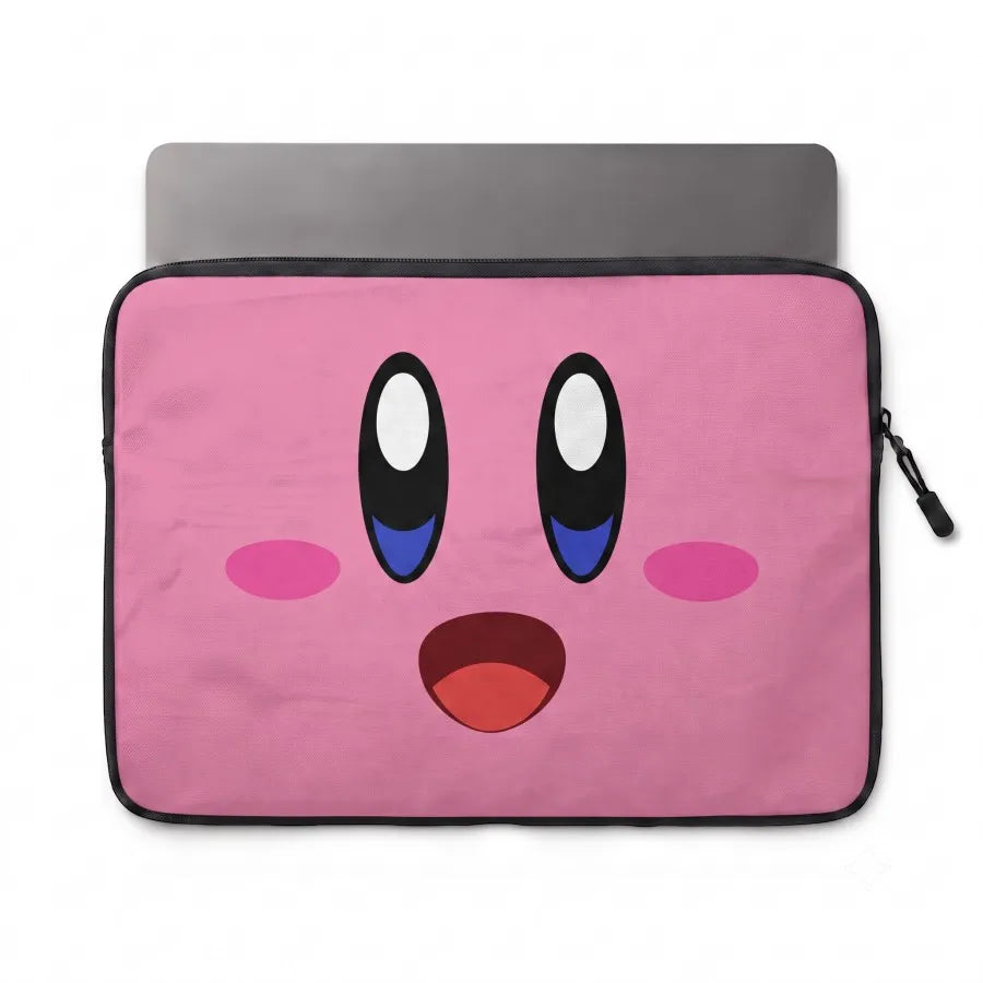 A pink laptop sleeve featuring a cartoon face inspired by Kirby, with large black and white eyes, blue under-eye details, pink cheeks, and an open red mouth. A gray laptop is partially visible inside the sleeve on a white background.