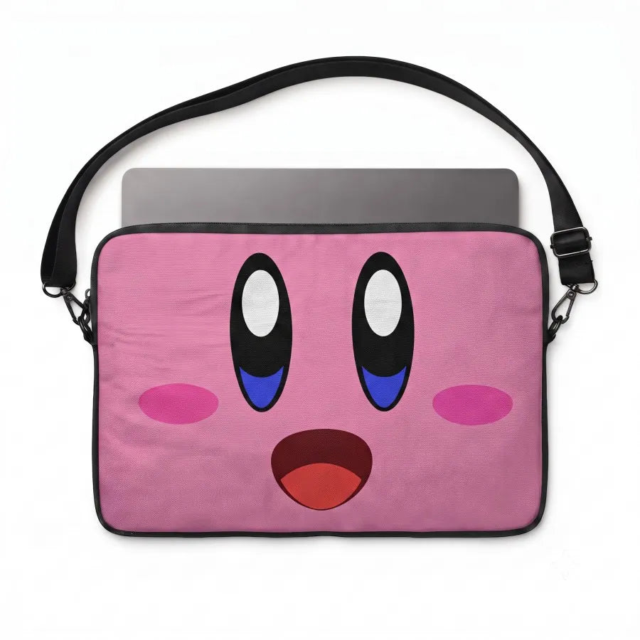 A pink laptop sleeve featuring a cartoon face design with large black and white eyes, blue pupils, pink cheeks, and an open red mouth. The sleeve is shown with a black shoulder strap and a gray laptop partially inserted, on a plain white background.