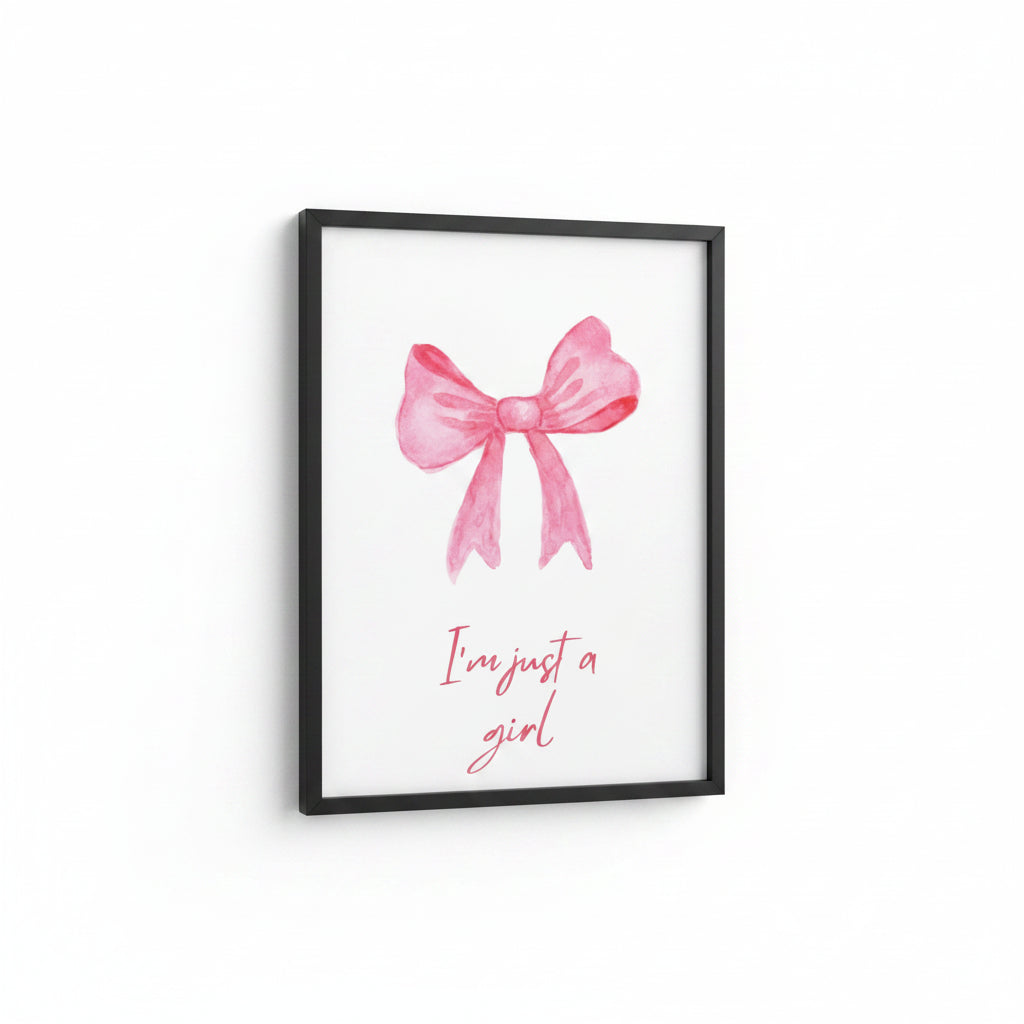 Framed artwork with a pink bow and 'I'm just a girl' text on a white background